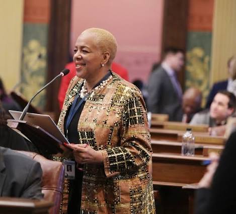 Cynthia A. Johnson, Cody alumna and former Michigan state representative, speaking at a podium in the House chamber